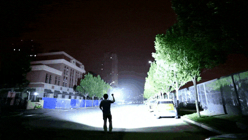 High power flashlight illuminating a dark outdoor area